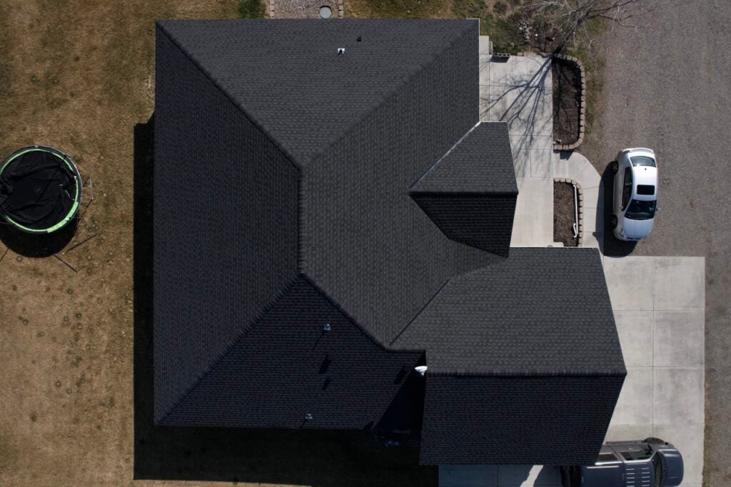 overhead view of charcoal black shingle roof with car parked in front in washington