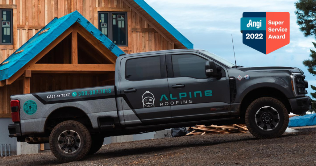 alpine roofing truck in front of wood cabin with angi award superimposed on photo