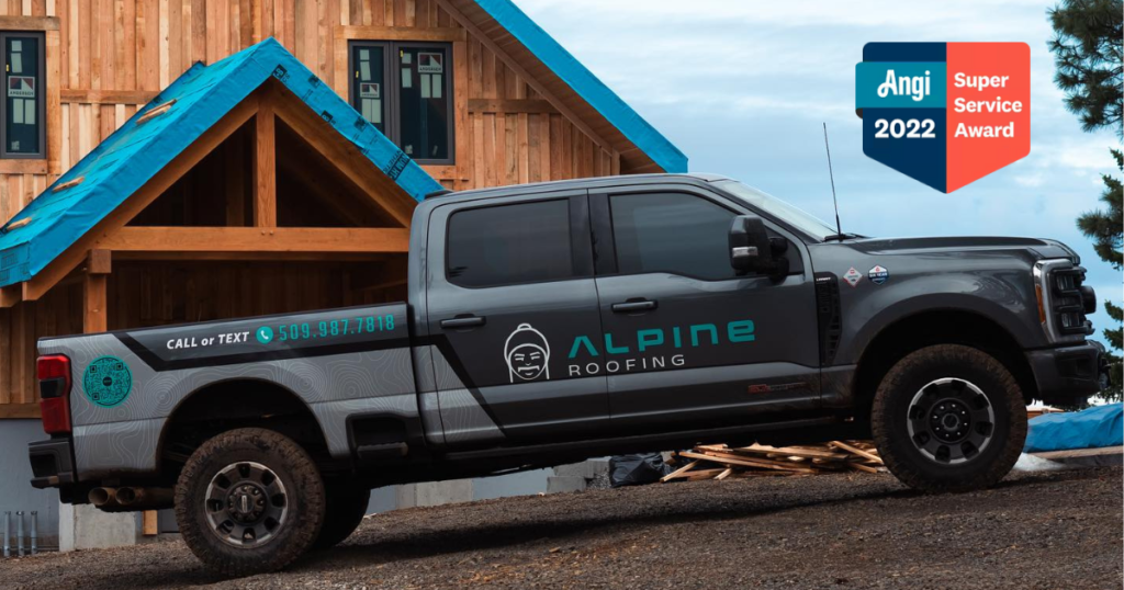 alpine roofing truck in front of wood cabin getting new roof with Angi Service Award logo 