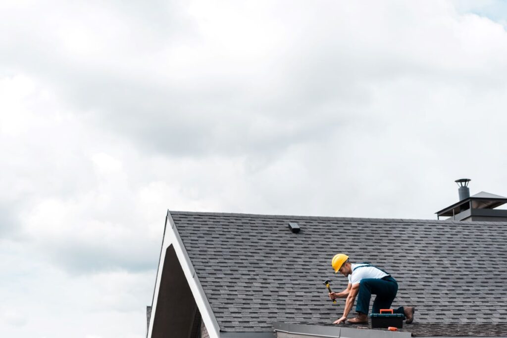 repairman in helmet on roof