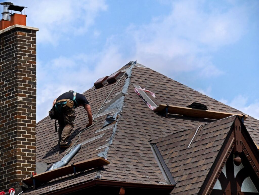 Worker repairing roof