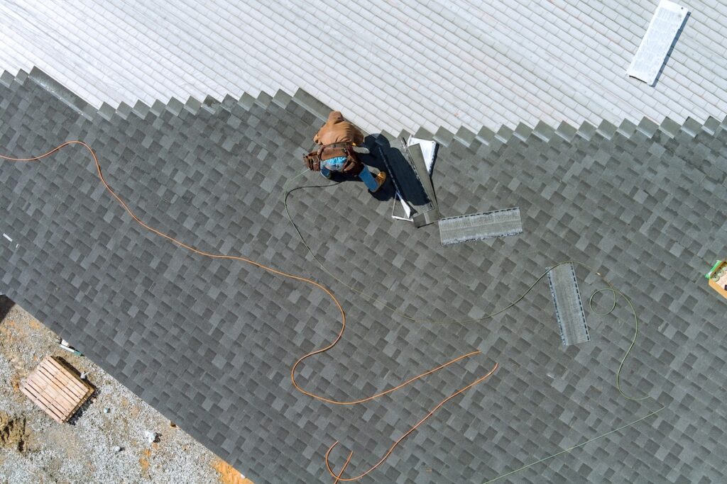 Aerial top view a asphalt shingles installation on the roof