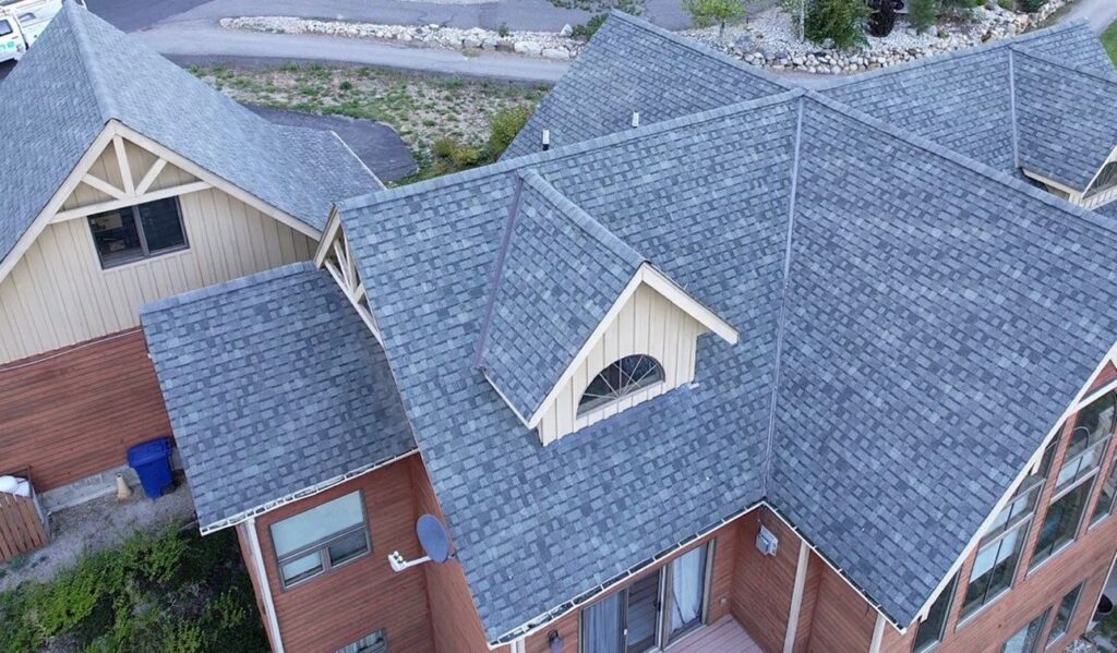 A large house with a light grey asphalt shingle roof
