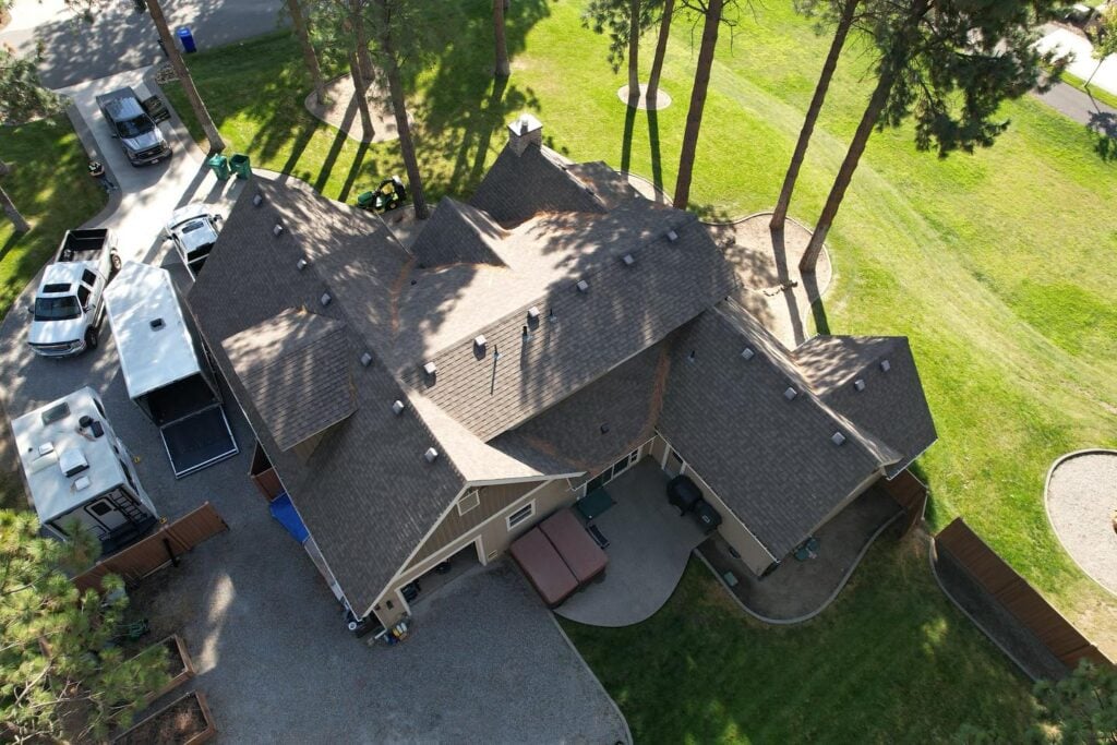 Aerial view of a big house with an asphalt shingle roof