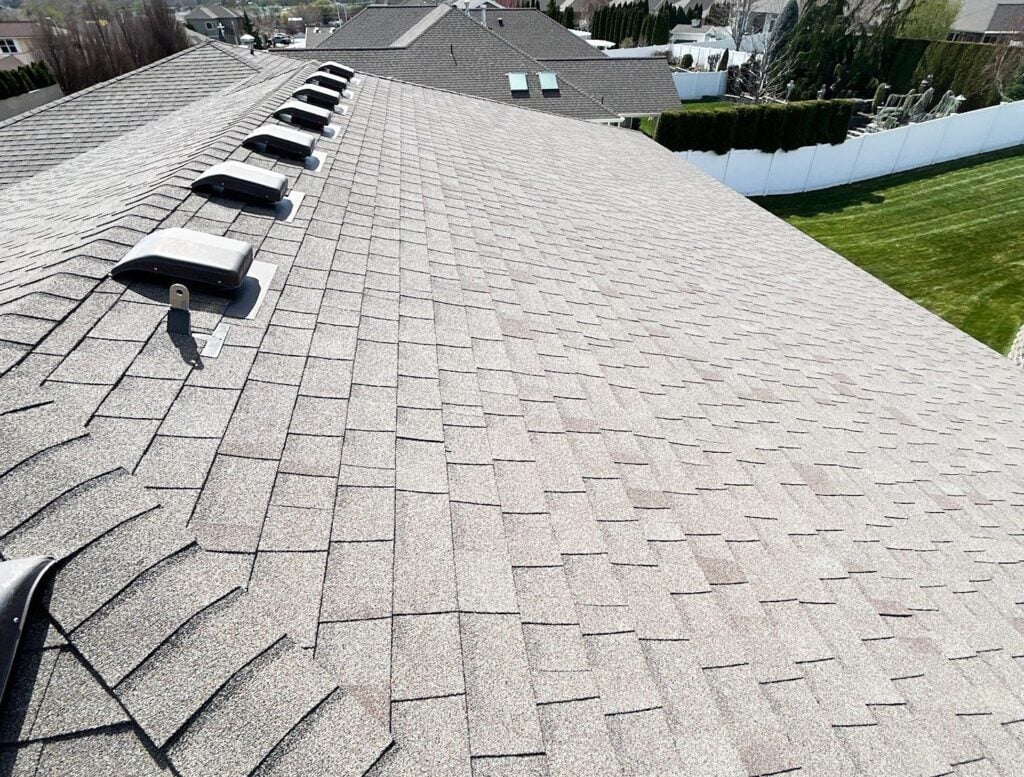 Close up of a grey asphalt shingle roof with vents