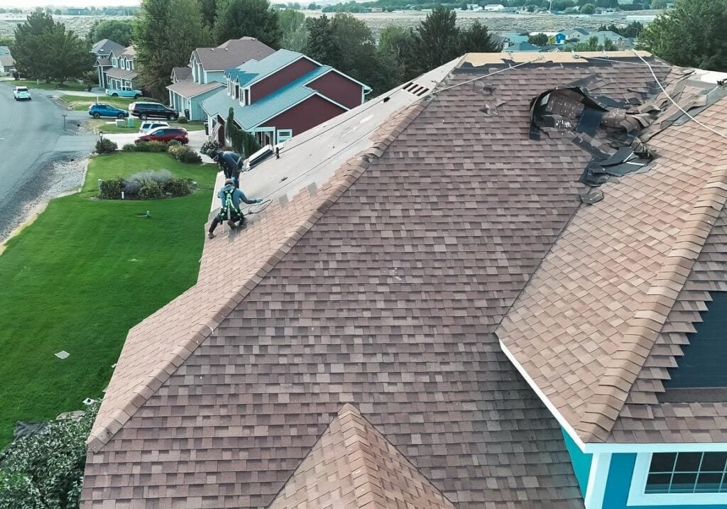 Alpine Roofing team installing shingles on a roof