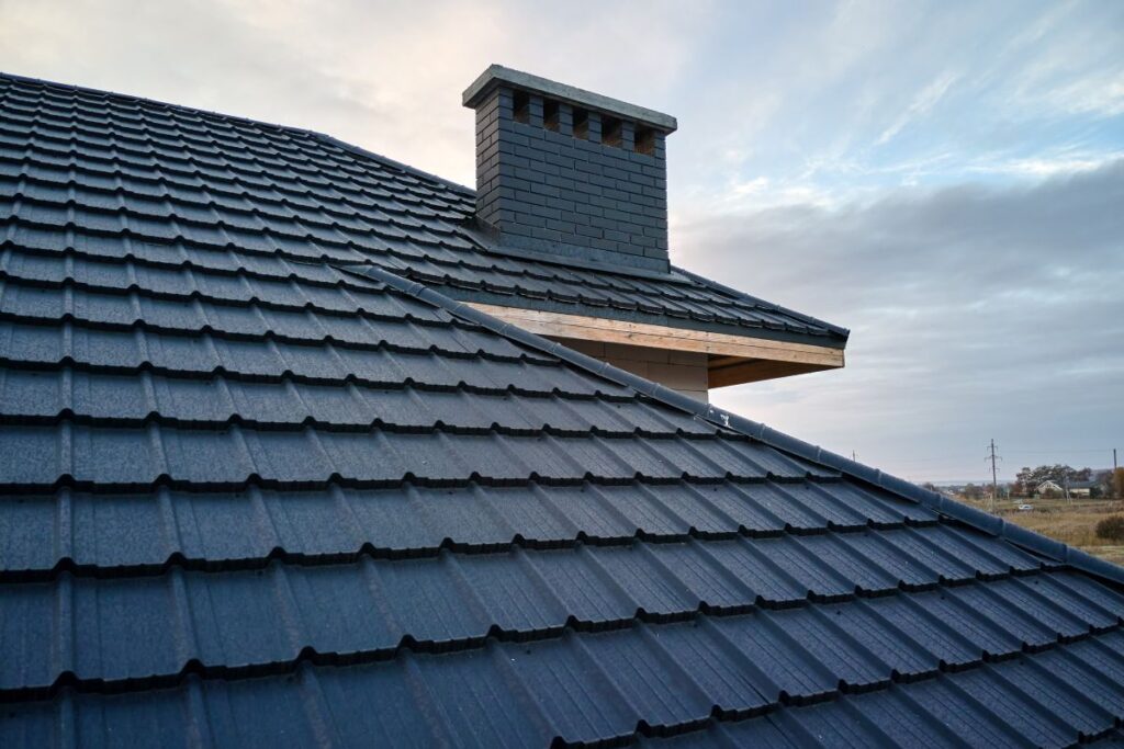 Closeup of house roof top covered with metallic shingles