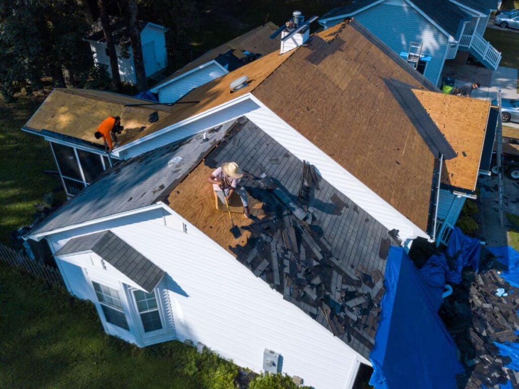 roof replacement cost Clarkston WA worker removing shingles