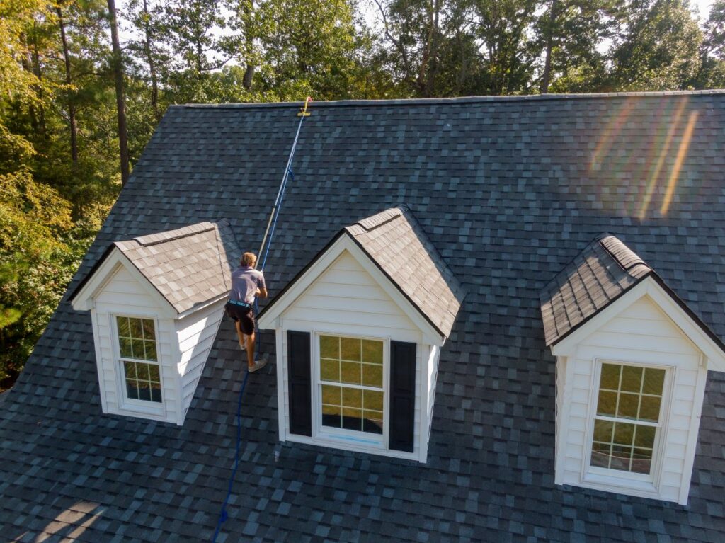 how to find a roof leak worker going up shingles