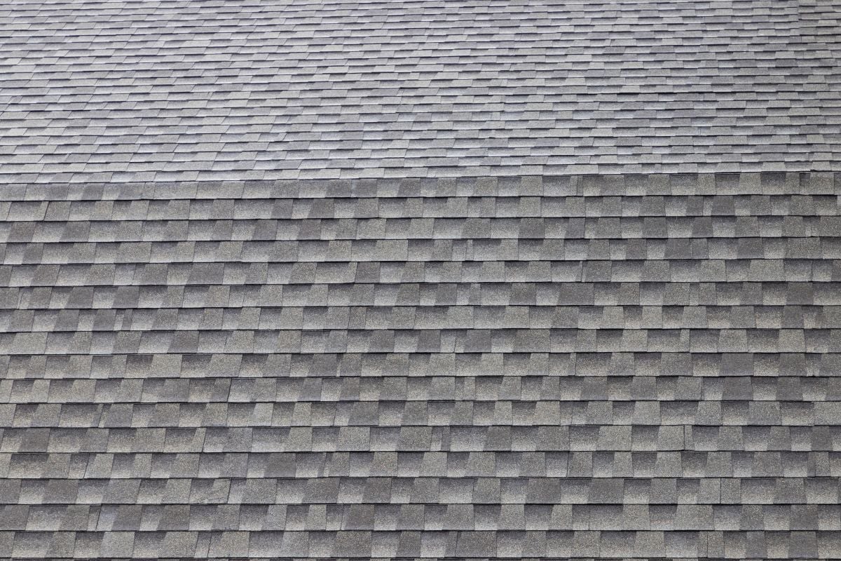 wet roof shingles background and texture. angle slope of asphalt roof.