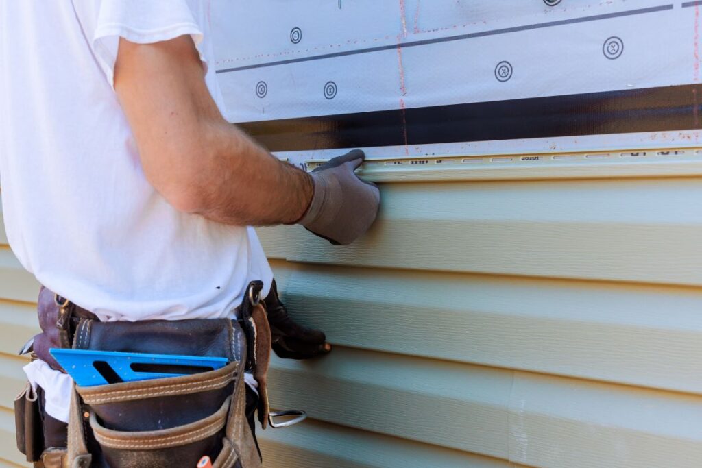 siding contractors spokane wa worker replacing old siding