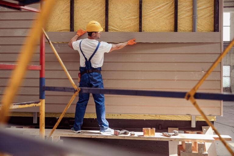 siding contractors spokane wa worker holding wood piece