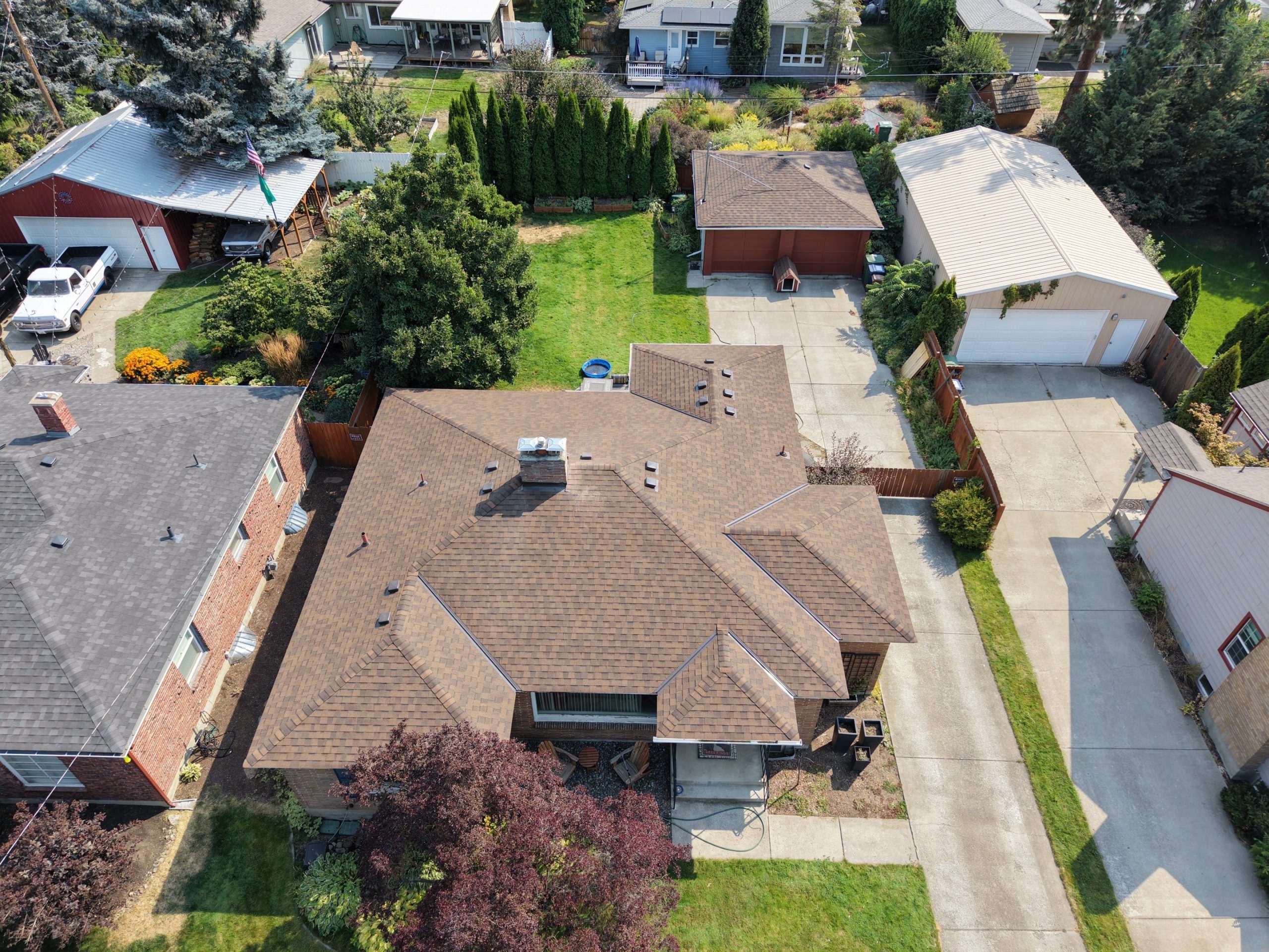 Aerial view of CertainTeed Landmark Burnt Sienna shingles on a completed roof replacement in South Hill Spokane