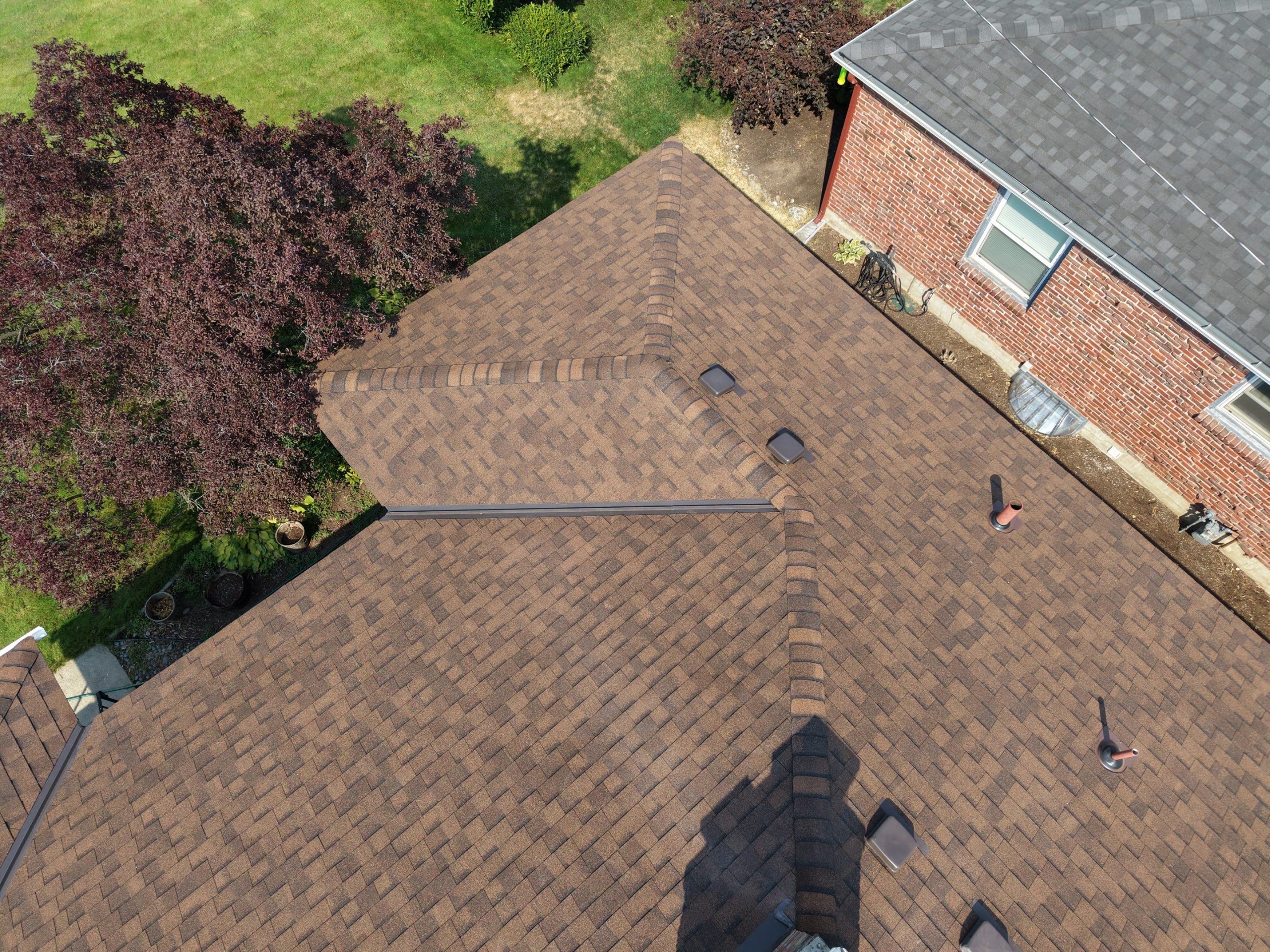 Close-up of CertainTeed Shadow Ridge hip and ridge cap and Landmark Burnt Sienna shingles on a Spokane roof