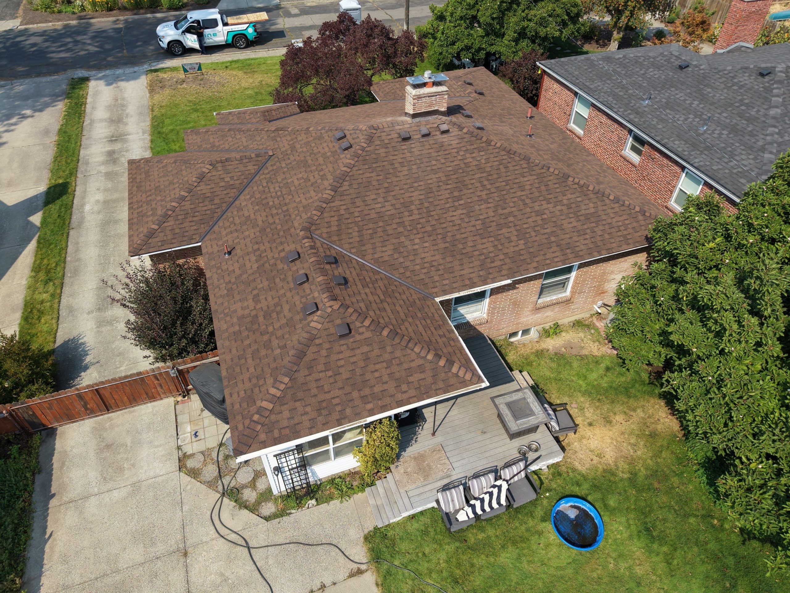 Completed new roof installation on West 36th Ave in Spokane's South Hill with the Alpine Roofing truck on site
